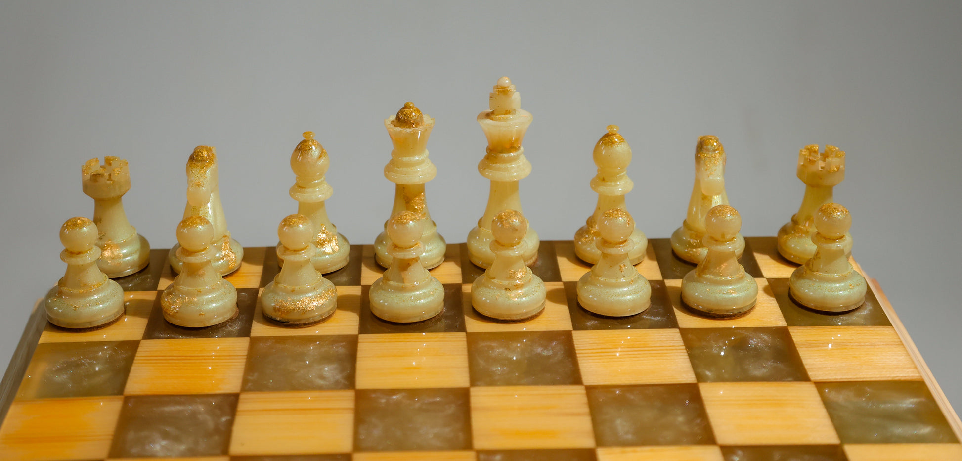 Granadas Amethyst Glow Chess Set – close-up of the purple and natural wood with epoxy resin pattern on the board
